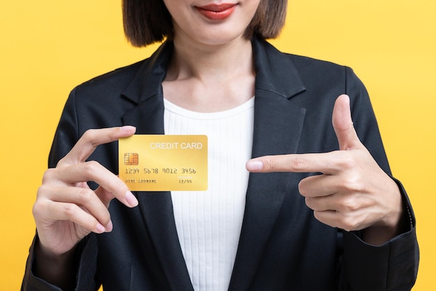 Close Up Asian Business Woman Smiling And Holding Gold Credit Card On Yellow Isolate Background 1654595 211