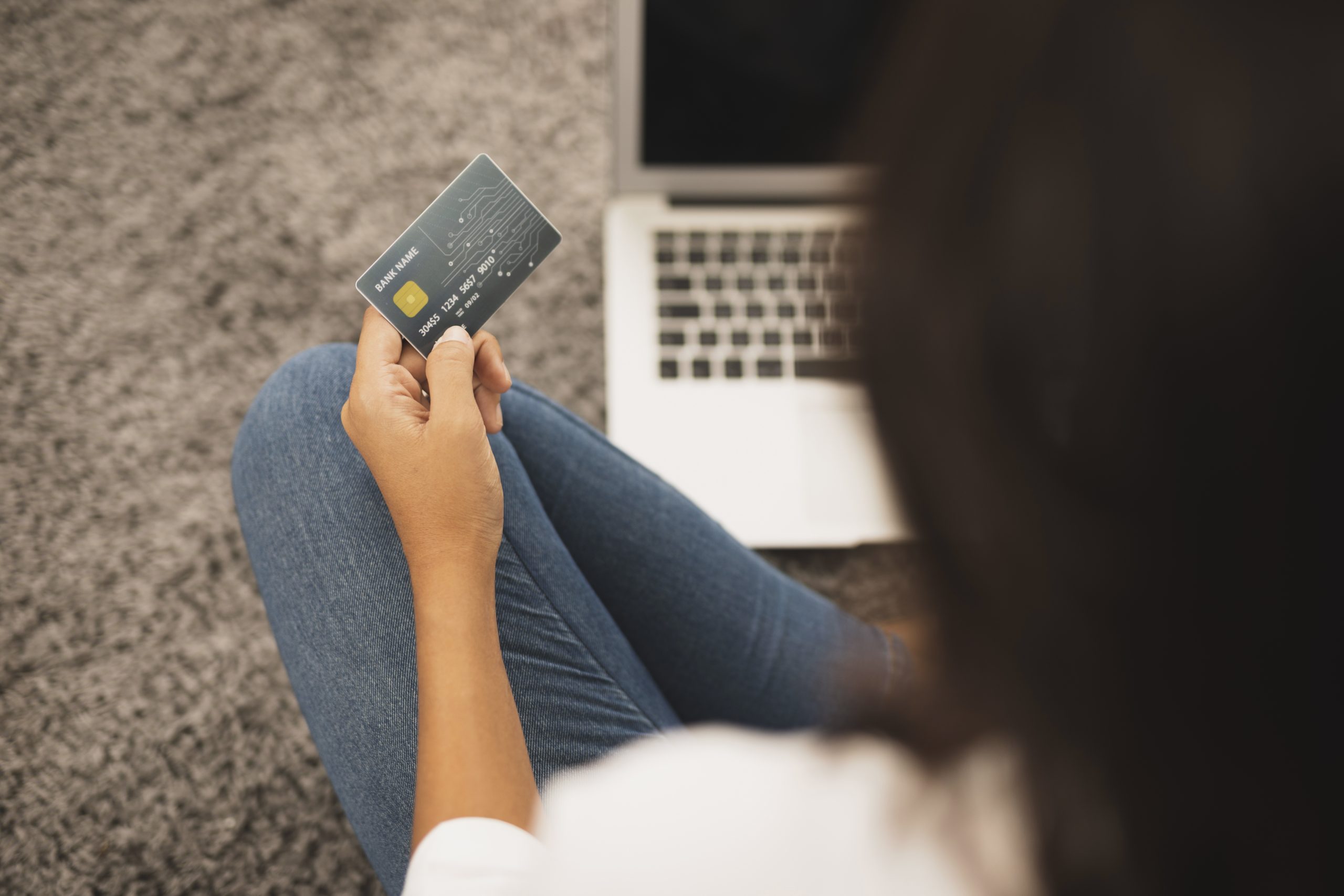 Back View Woman Holding Credit Card Floor Scaled
