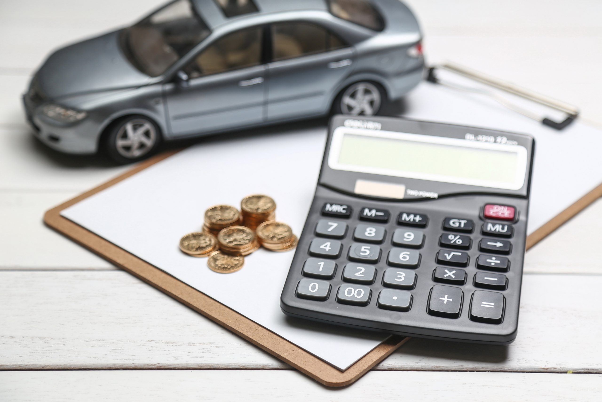 Car Model Calculator Coins White Table Scaled